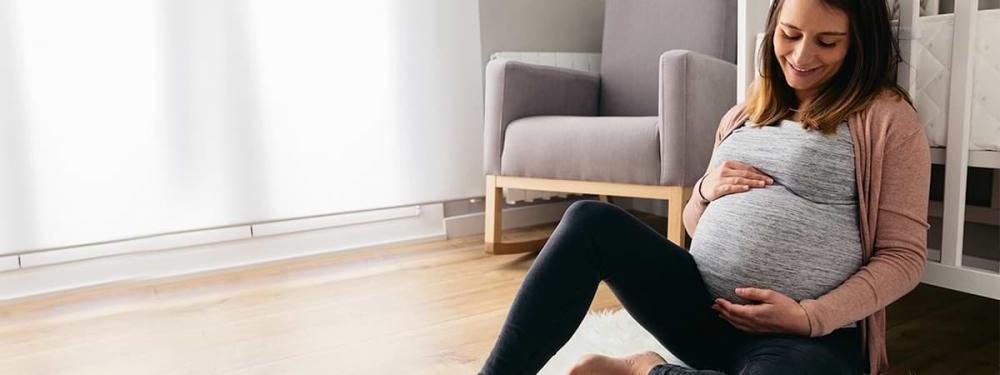 pregnant woman sitting on floor