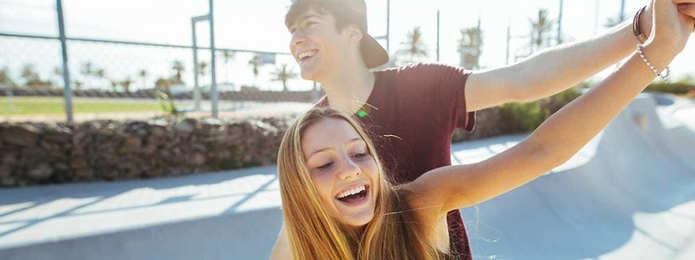 teen couple dancing outside